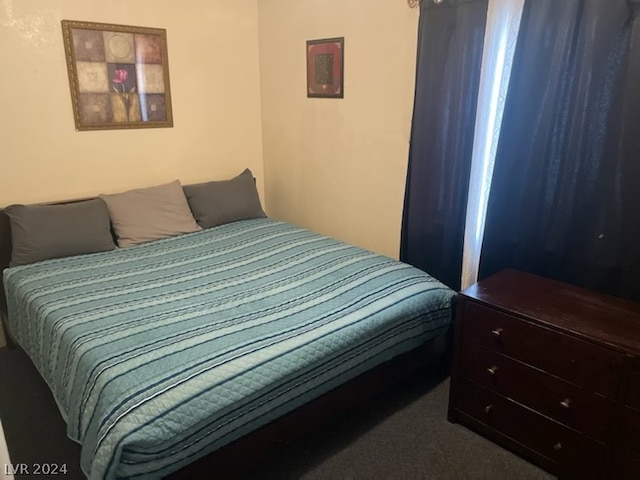 bedroom with dark colored carpet