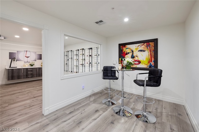 interior space with light hardwood / wood-style flooring and indoor bar