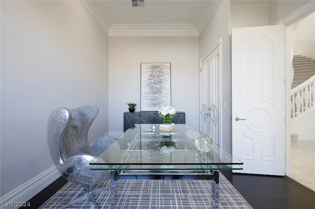 dining room featuring dark wood-type flooring and ornamental molding