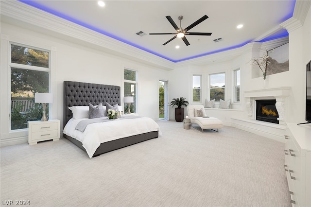 carpeted bedroom featuring crown molding, ceiling fan, and a tray ceiling