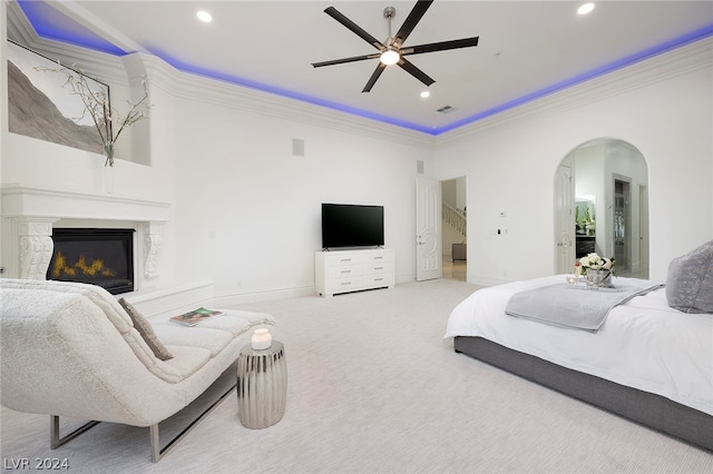 carpeted bedroom with ceiling fan and ornamental molding