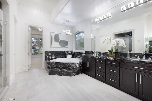 bathroom featuring vanity, ornamental molding, and tiled bath