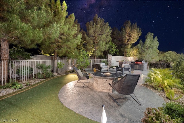 view of patio with area for grilling and an outdoor fire pit