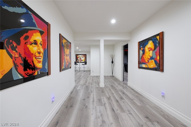 hallway with light hardwood / wood-style flooring