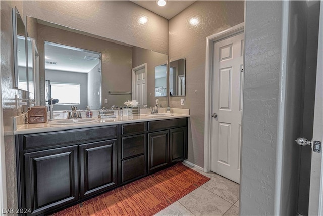 bathroom with double sink vanity and tile floors