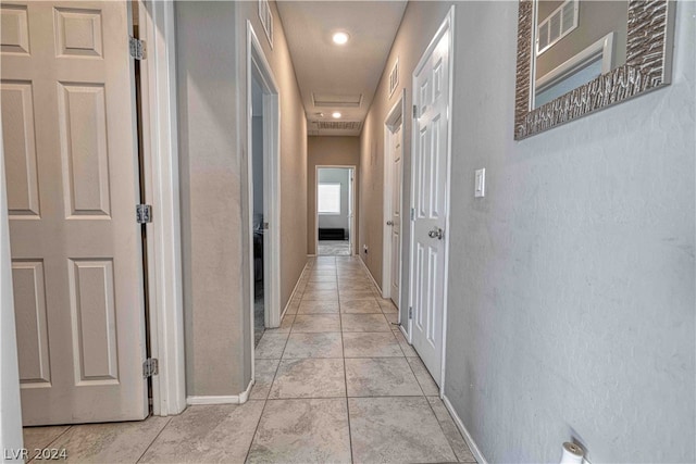 corridor with light tile floors