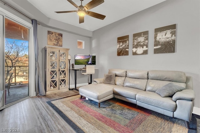 living room featuring ceiling fan and hardwood / wood-style flooring