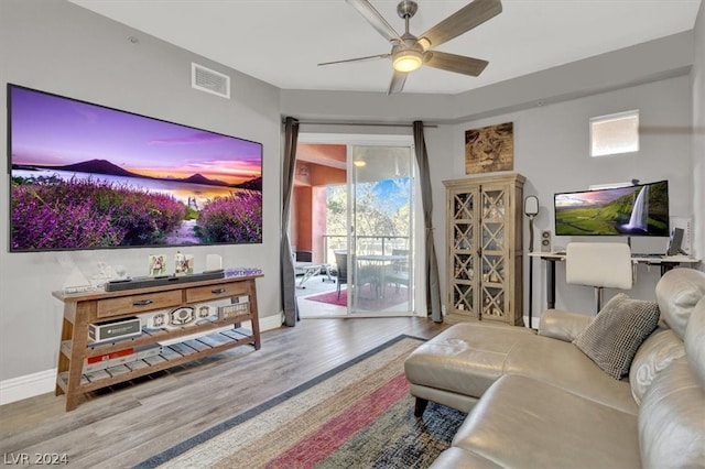 living room with wood-type flooring and ceiling fan