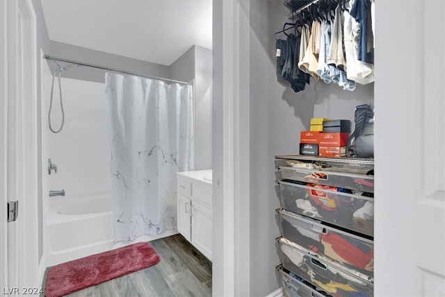 bathroom featuring hardwood / wood-style floors, vanity, and shower / bath combo with shower curtain