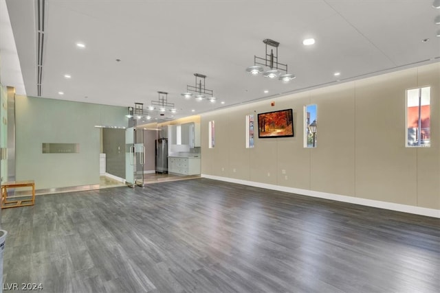 unfurnished living room with dark wood-type flooring