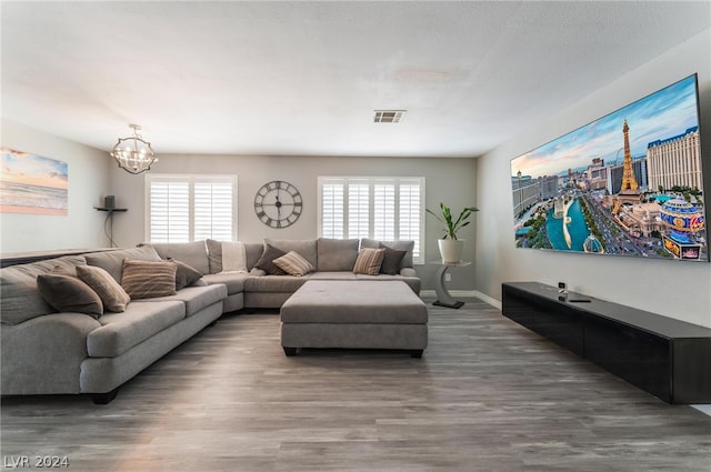 living room with a chandelier and dark hardwood / wood-style flooring