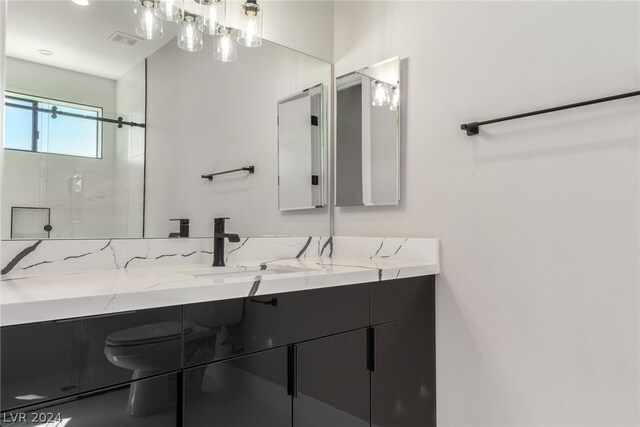 bathroom featuring walk in shower and vanity