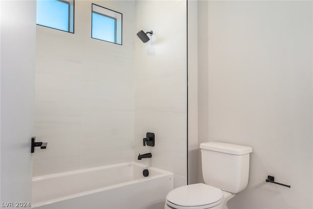 bathroom featuring shower / bathtub combination and toilet