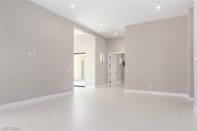 unfurnished room featuring a towering ceiling