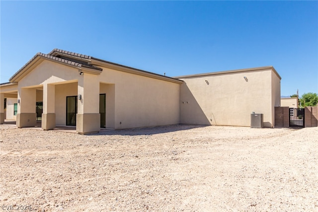 rear view of house featuring cooling unit