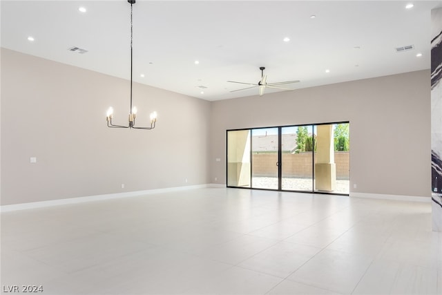 unfurnished room with ceiling fan with notable chandelier