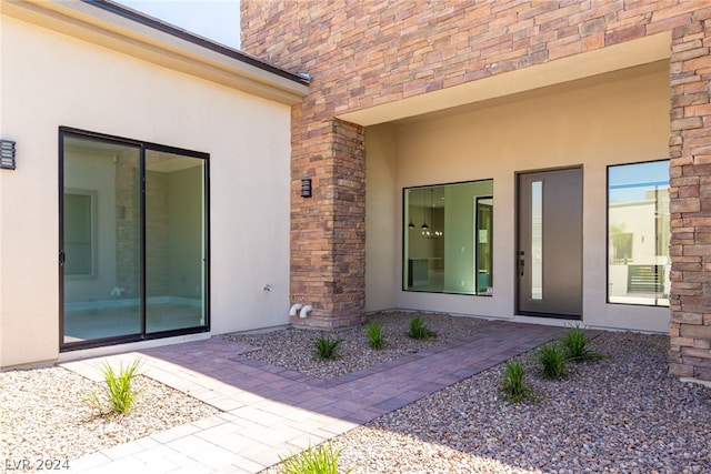 entrance to property featuring a patio