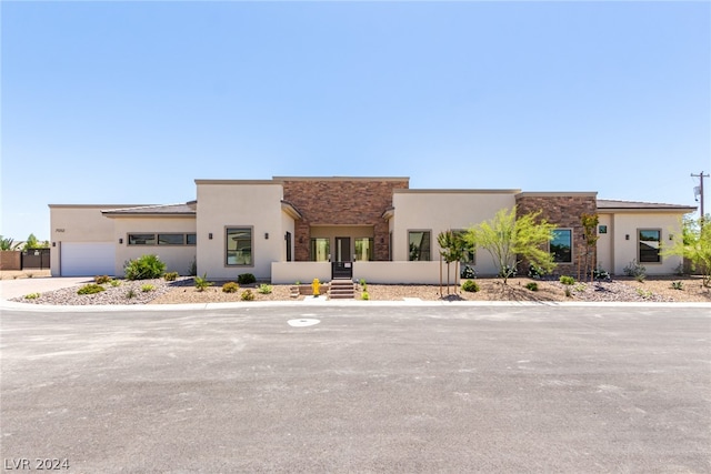 pueblo-style home with a garage