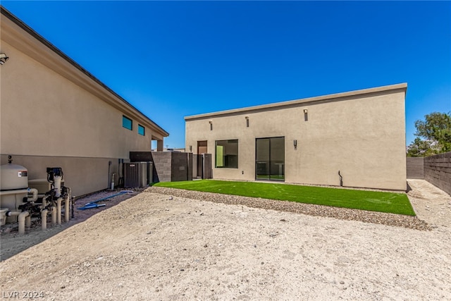 rear view of property with a yard