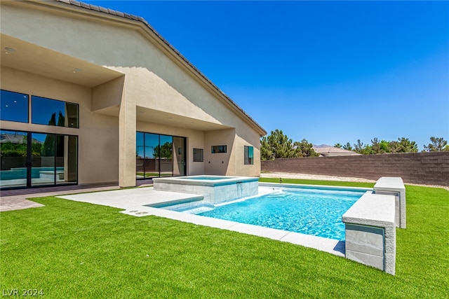 view of pool featuring a patio, an in ground hot tub, and a yard