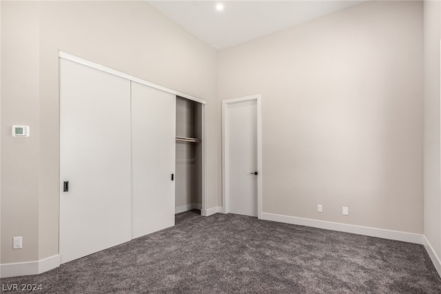 unfurnished bedroom with a closet and carpet flooring