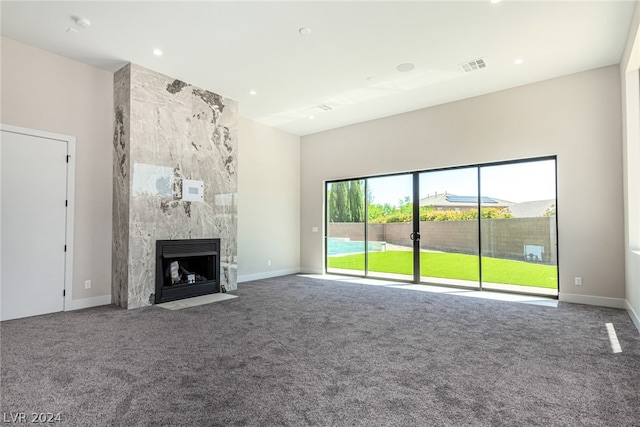 unfurnished living room featuring a premium fireplace and carpet flooring