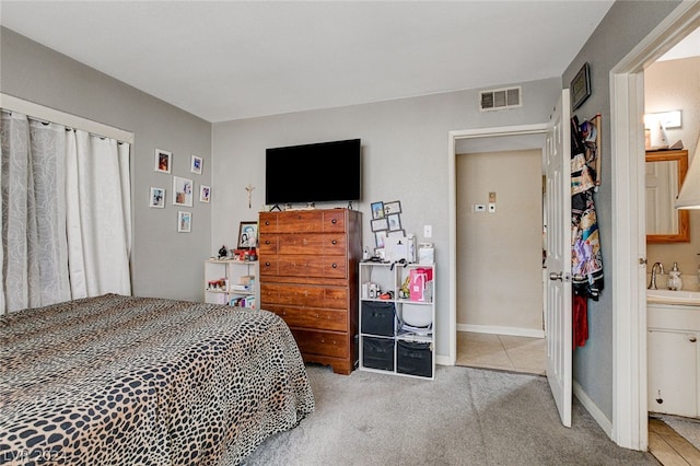 carpeted bedroom featuring sink