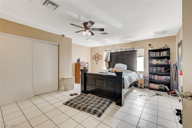 bedroom with ceiling fan and light tile floors