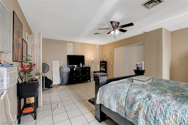 tiled bedroom featuring ceiling fan