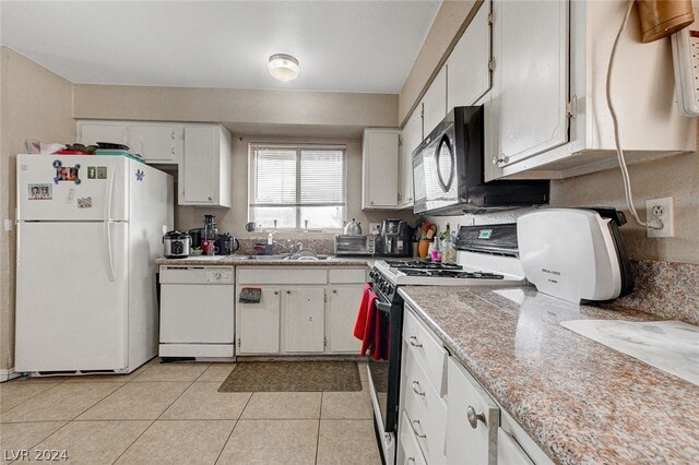 kitchen featuring white cabinets, sink, white appliances, and light tile flooring