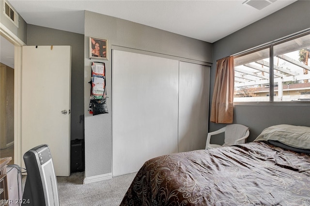 bedroom featuring a closet, carpet floors, and multiple windows