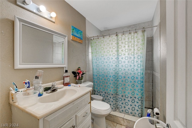 bathroom with vanity with extensive cabinet space, toilet, and tile flooring