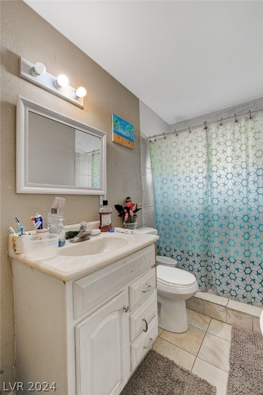 bathroom with tile floors, vanity with extensive cabinet space, and toilet