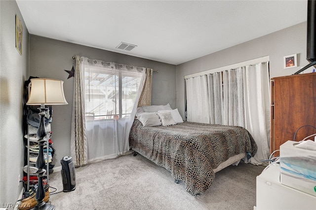 bedroom featuring light colored carpet