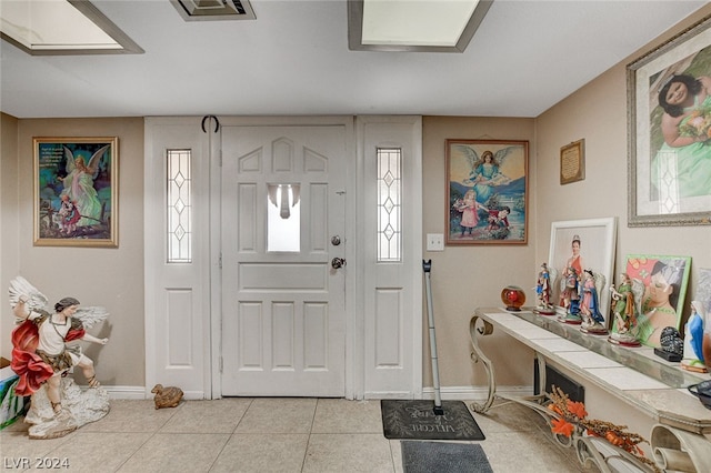 tiled foyer entrance featuring a healthy amount of sunlight