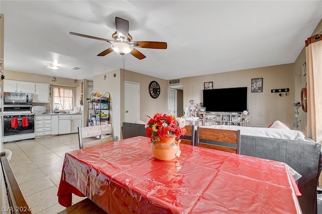 tiled dining area featuring ceiling fan