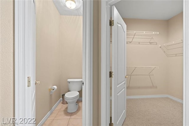 bathroom with toilet and tile flooring