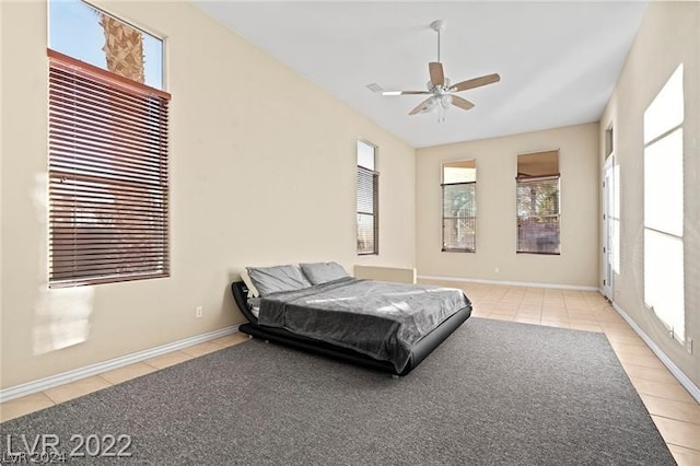 tiled bedroom featuring ceiling fan