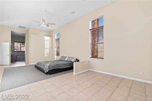 tiled bedroom featuring ceiling fan