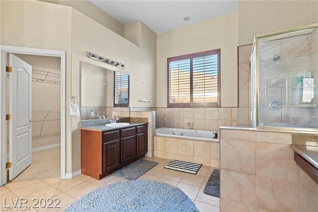 bathroom with tile floors, oversized vanity, and plus walk in shower