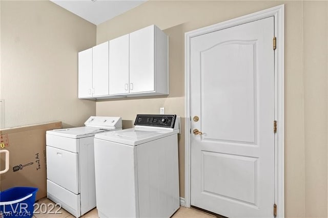 washroom with cabinets and separate washer and dryer