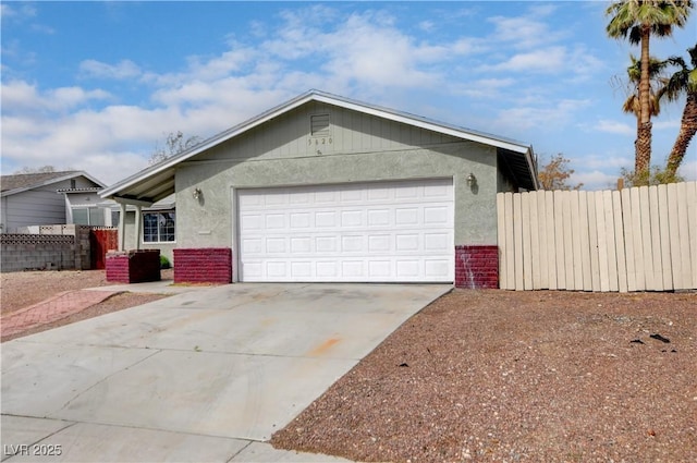 ranch-style home with brick siding, fence, stucco siding, a garage, and driveway