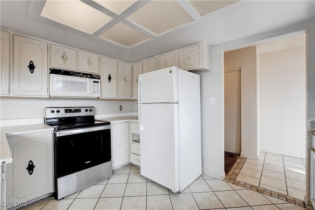 kitchen featuring white appliances, light tile patterned flooring, light countertops, and baseboards