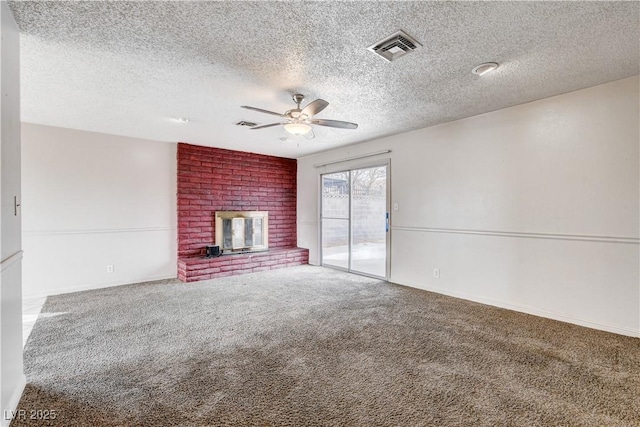 unfurnished living room featuring visible vents, a brick fireplace, carpet floors, a textured ceiling, and a ceiling fan