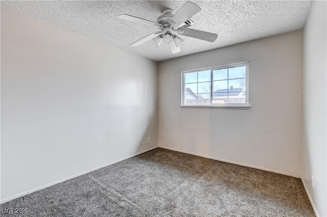 carpeted spare room with a ceiling fan, baseboards, and a textured ceiling