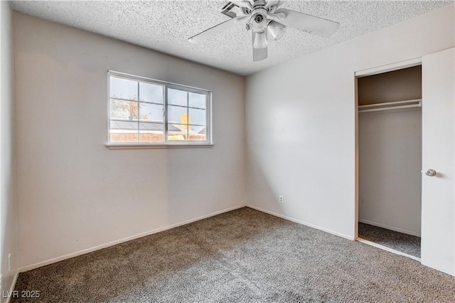 unfurnished bedroom featuring baseboards, carpet, a closet, and a textured ceiling