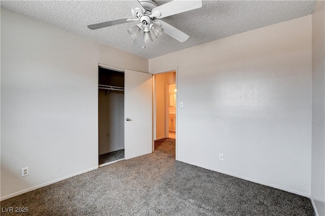 unfurnished bedroom featuring baseboards, carpet flooring, a closet, a textured ceiling, and a ceiling fan