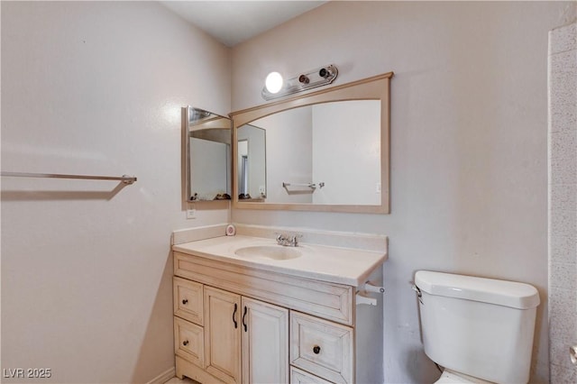 bathroom featuring toilet and vanity