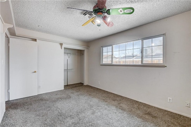 unfurnished bedroom with a closet, a textured ceiling, ceiling fan, and carpet flooring