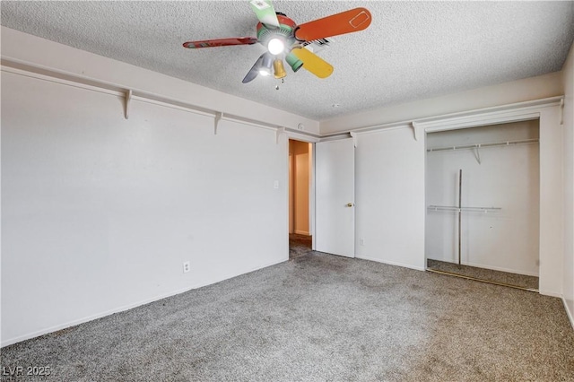 unfurnished bedroom with a closet, a textured ceiling, carpet flooring, and a ceiling fan